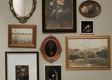 Chic wall art at Unorthodox Salon in Taylors, South Carolina, US, showcasing vintage frames and floral motifs.