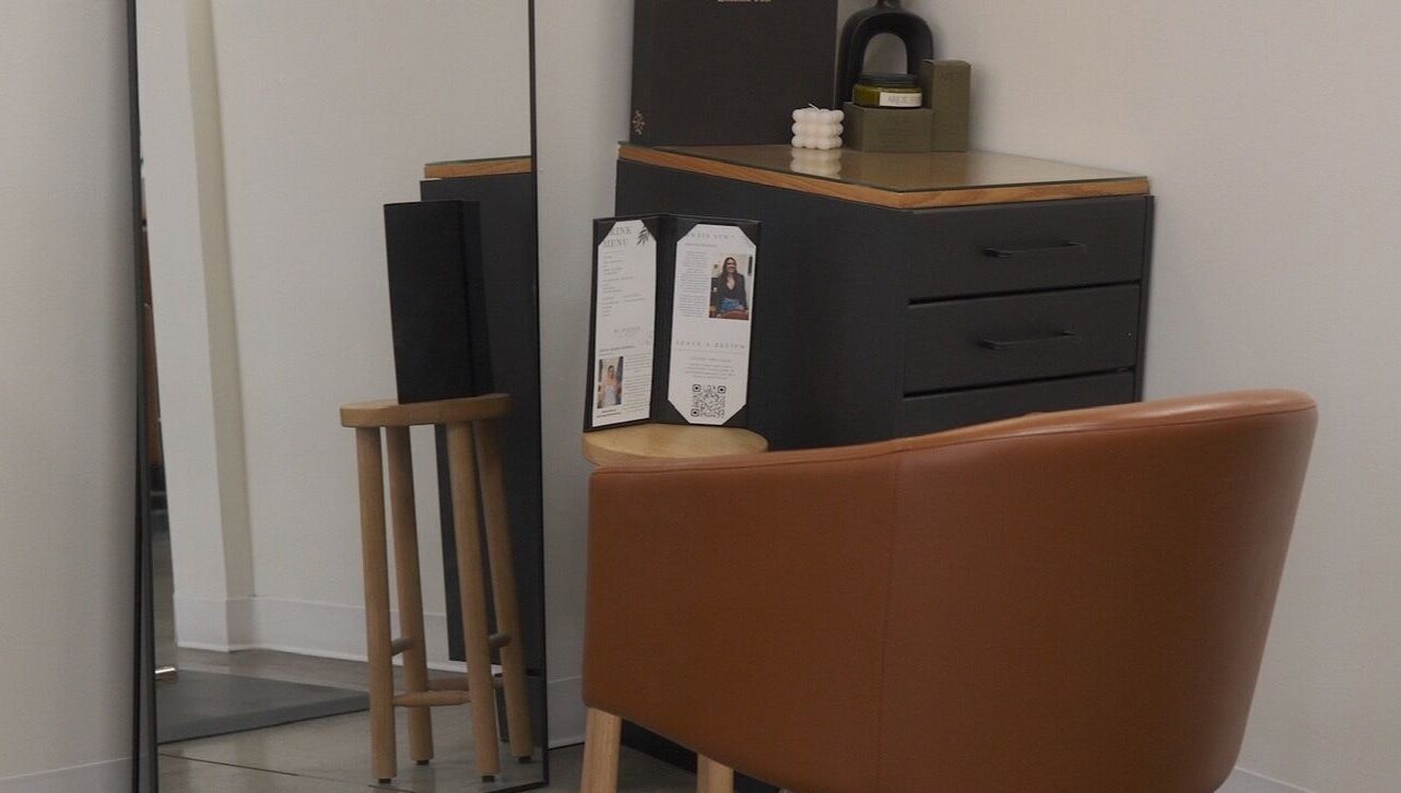 Modern styling station with mirror and brown chair at Unorthodox Salon, Taylors, South Carolina, US.