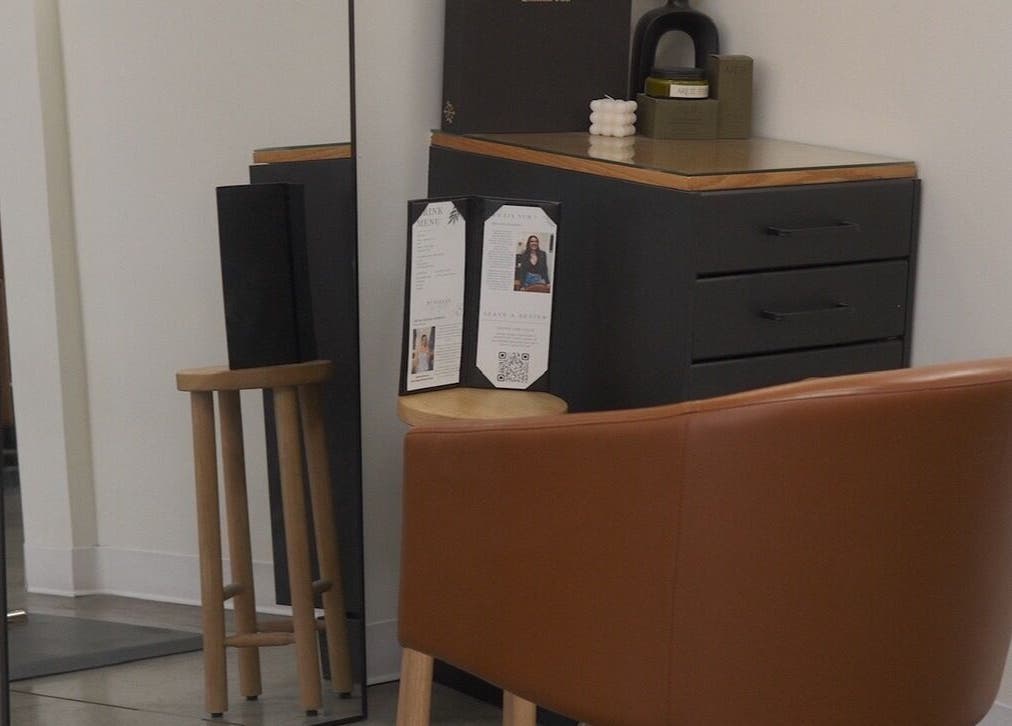 Modern styling station with mirror and brown chair at Unorthodox Salon, Taylors, South Carolina, US.