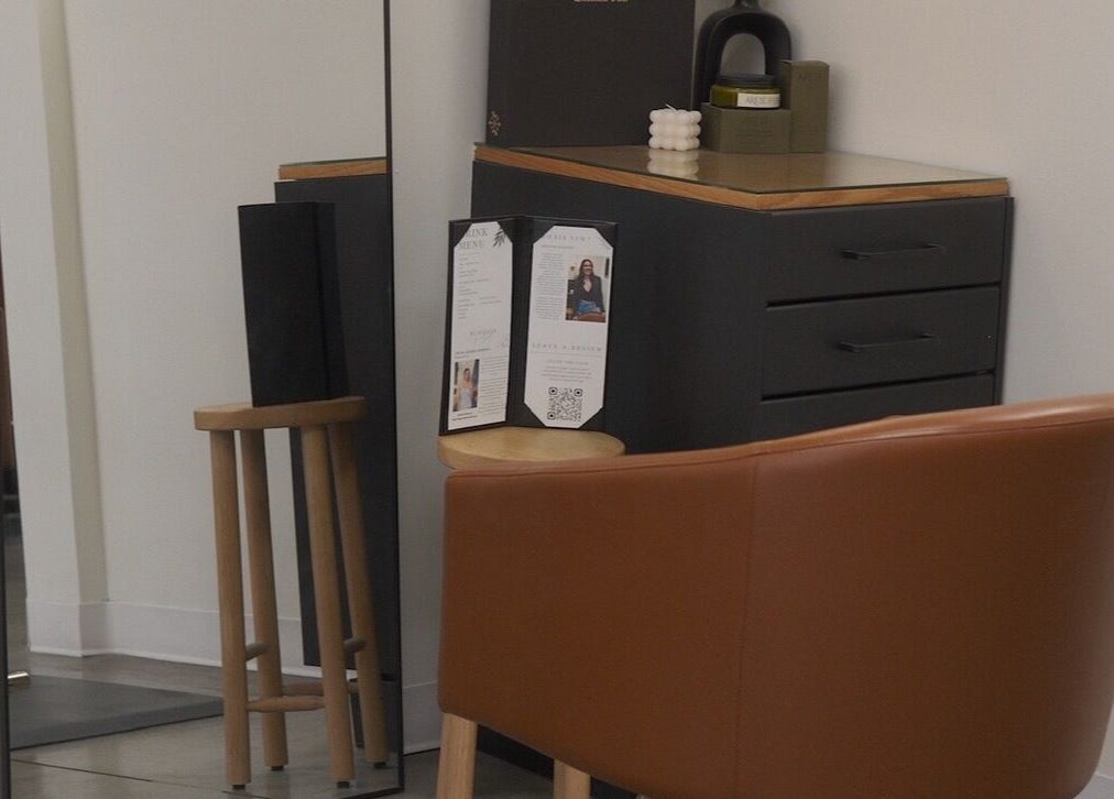 Modern styling station with mirror and brown chair at Unorthodox Salon, Taylors, South Carolina, US.