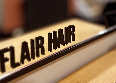 Flair Hair sign reflection at beauty salon in Peebles, Scotland, GB.