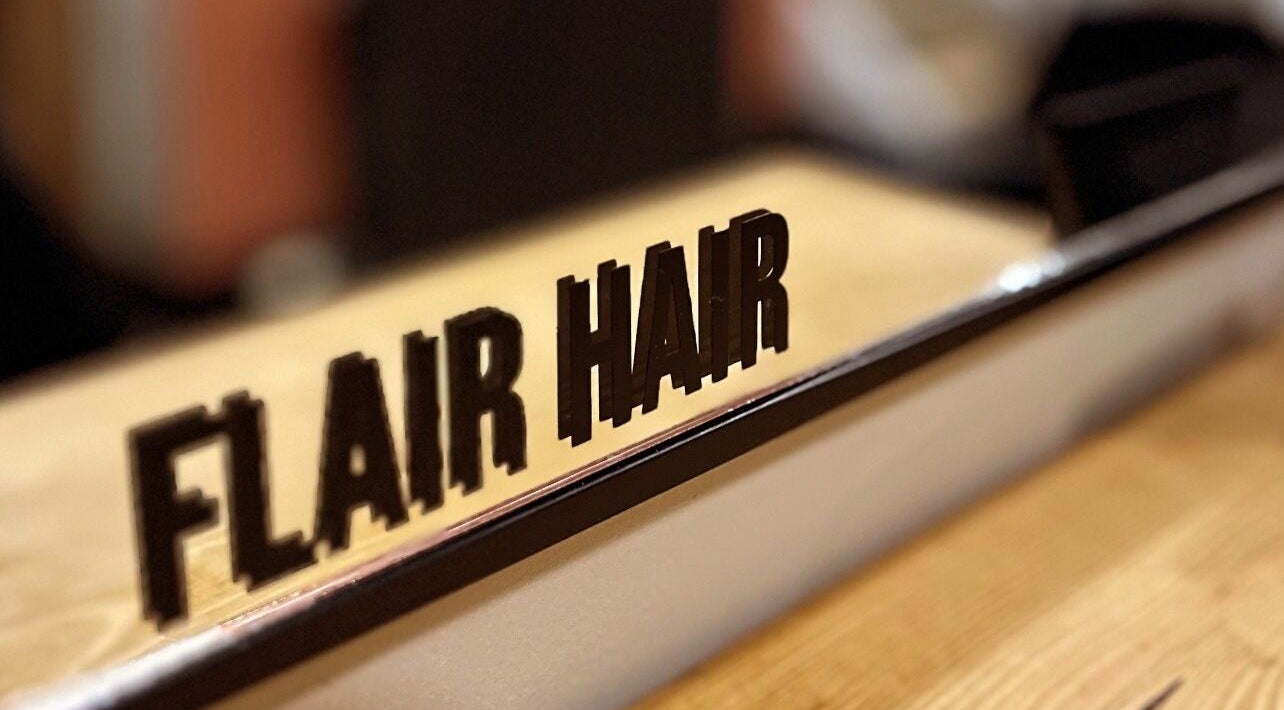 Flair Hair sign reflection at beauty salon in Peebles, Scotland, GB.