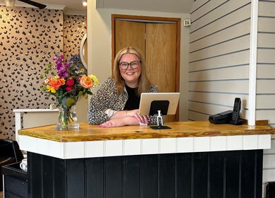 Welcoming reception at Flair Hair, Peebles, Scotland, GB with vibrant flowers and smiling staff.
