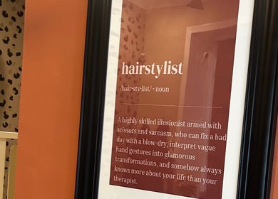 Artistic hairstylist definition on leopard print wall at Flair Hair in Peebles, Scotland, GB.