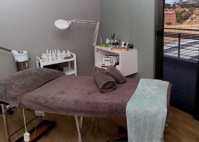 Relaxing treatment room at Origin Wellness Spa, Cape Town, Western Cape, ZA, featuring a cozy massage bed.