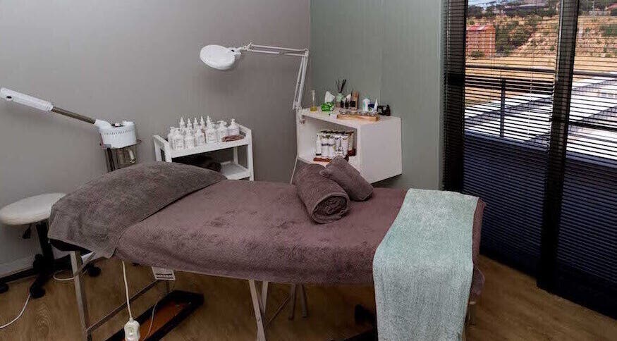 Relaxing treatment room at Origin Wellness Spa, Cape Town, Western Cape, ZA, featuring a cozy massage bed.