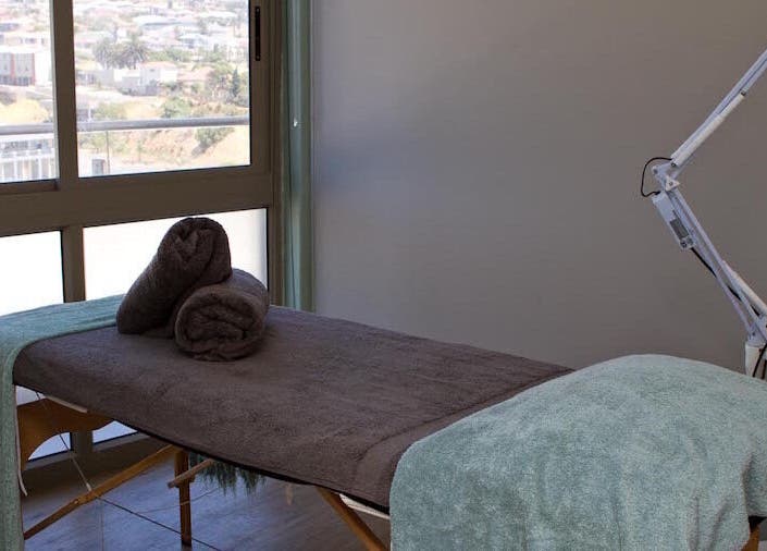 Luxurious treatment room at Origin Wellness Spa, Cape Town, Western Cape, ZA, overlooking scenic views.