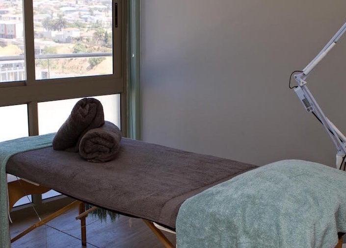 Luxurious treatment room at Origin Wellness Spa, Cape Town, Western Cape, ZA, overlooking scenic views.