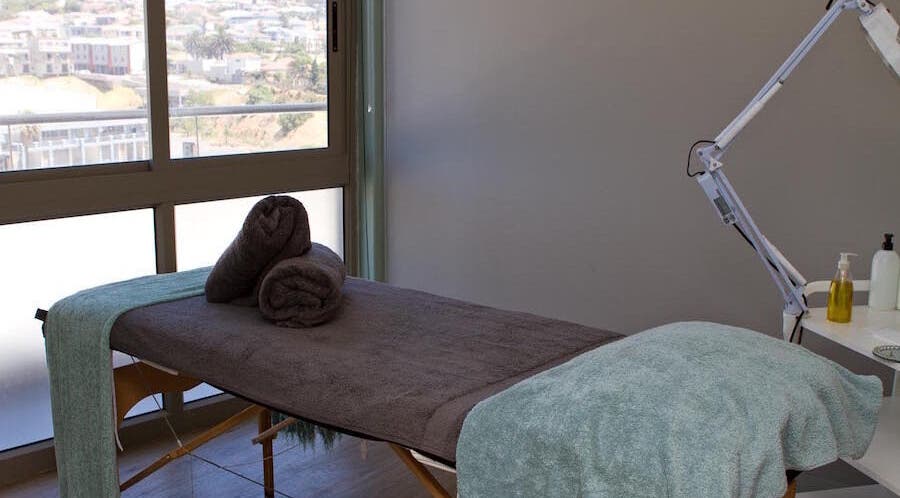 Luxurious treatment room at Origin Wellness Spa, Cape Town, Western Cape, ZA, overlooking scenic views.