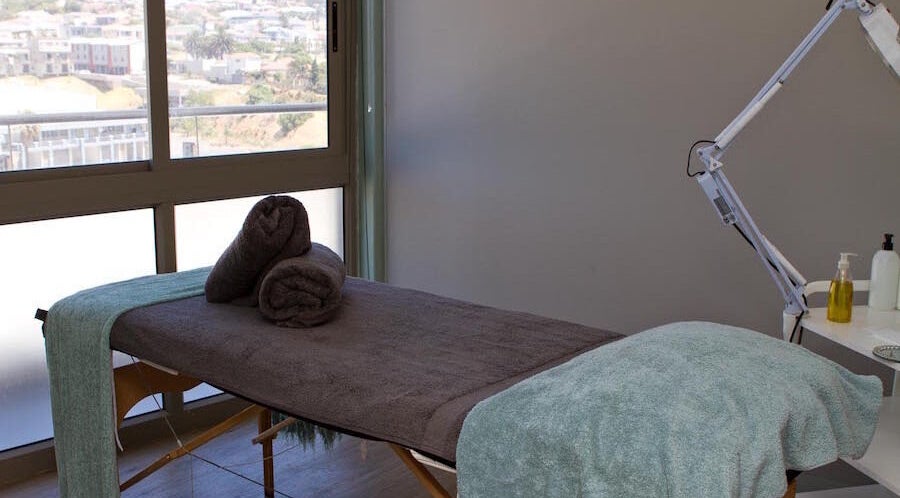 Luxurious treatment room at Origin Wellness Spa, Cape Town, Western Cape, ZA, overlooking scenic views.