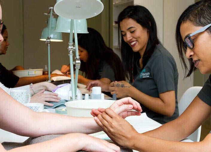 Clients receiving hand massage at Origin Wellness Spa, Cape Town, Western Cape, ZA.