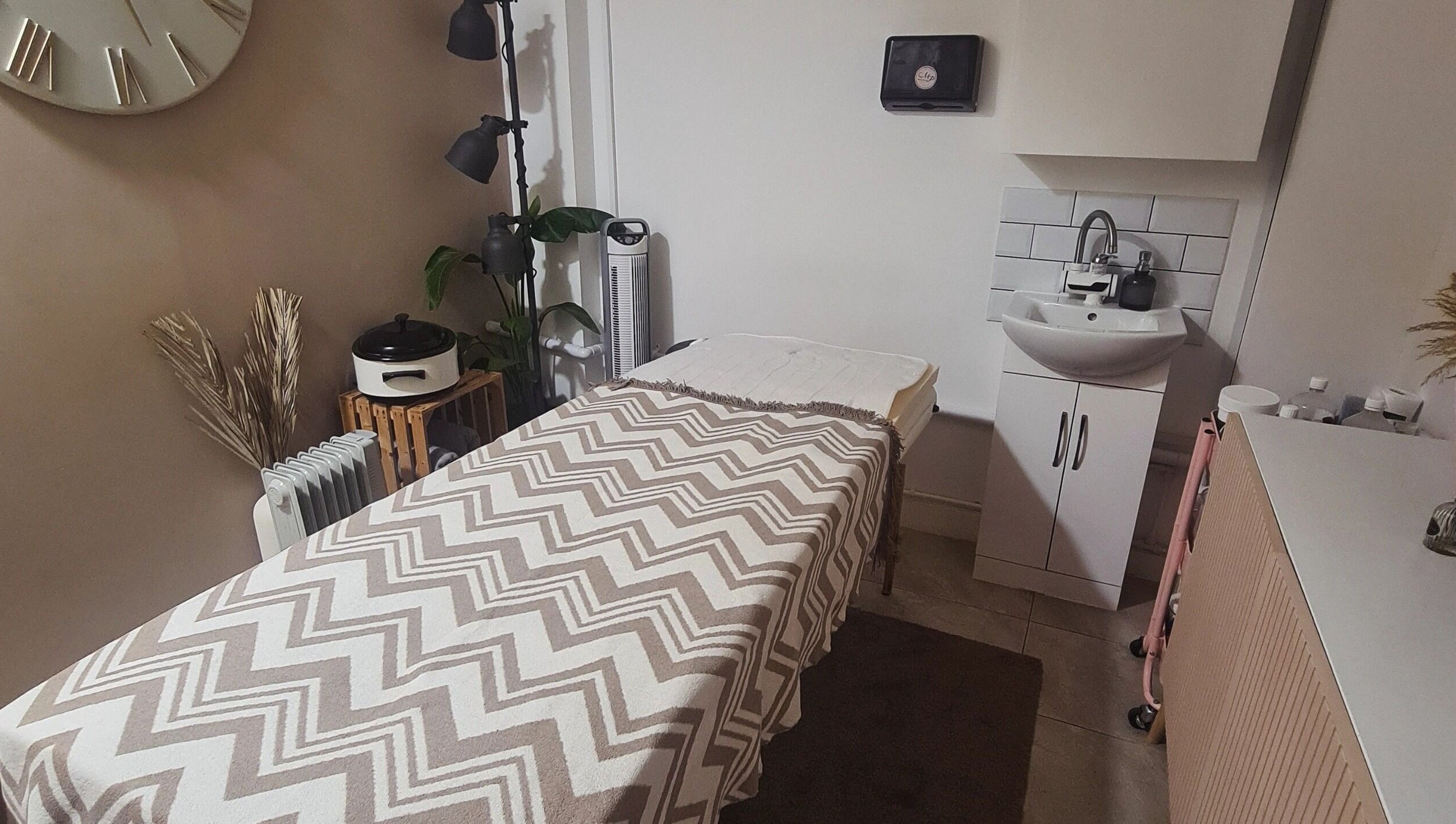 Tranquil therapy room at Happy Body - Massage & Physiotherapy, Peterborough, England, GB with warm decor.