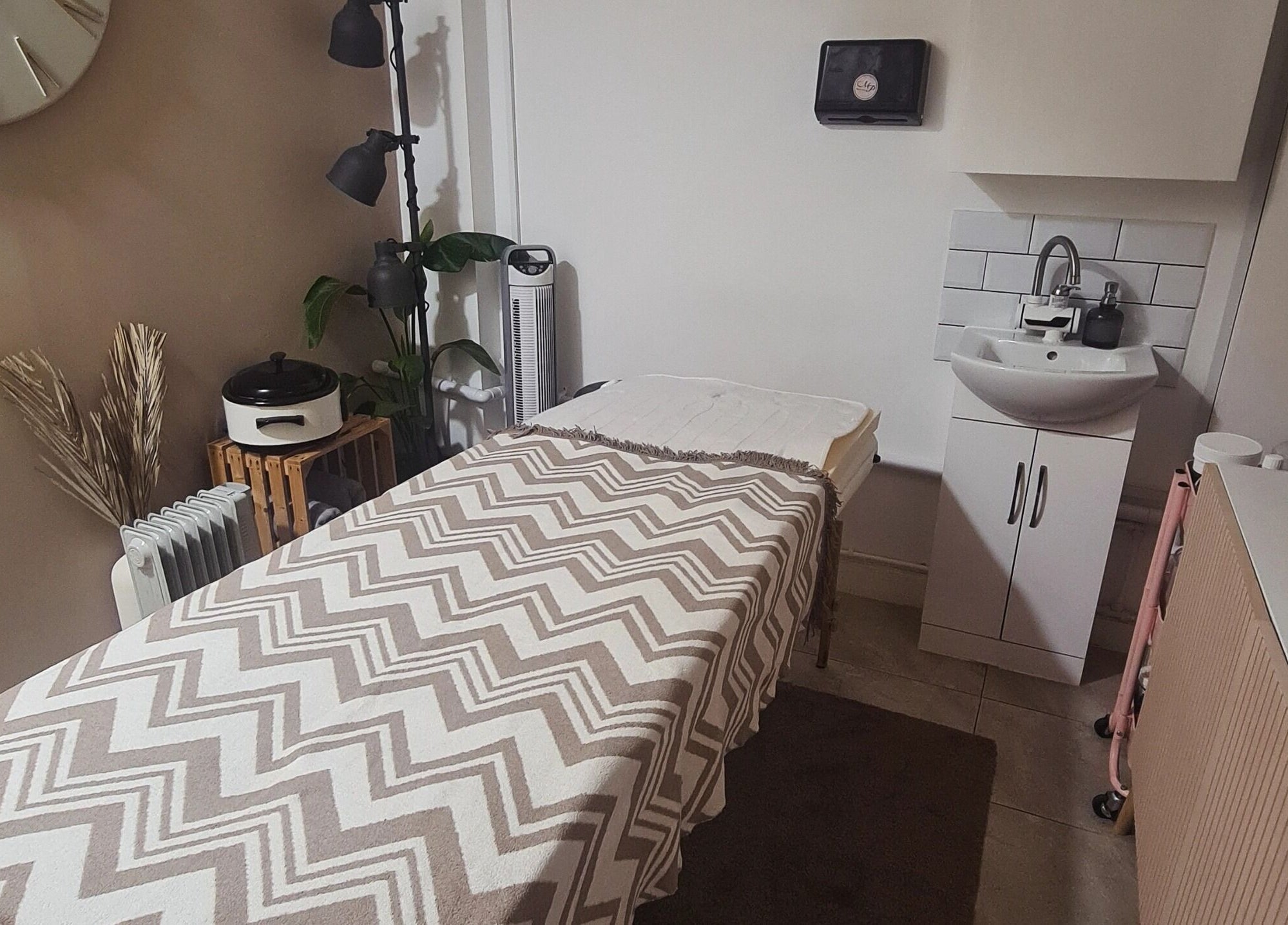 Tranquil therapy room at Happy Body - Massage & Physiotherapy, Peterborough, England, GB with warm decor.