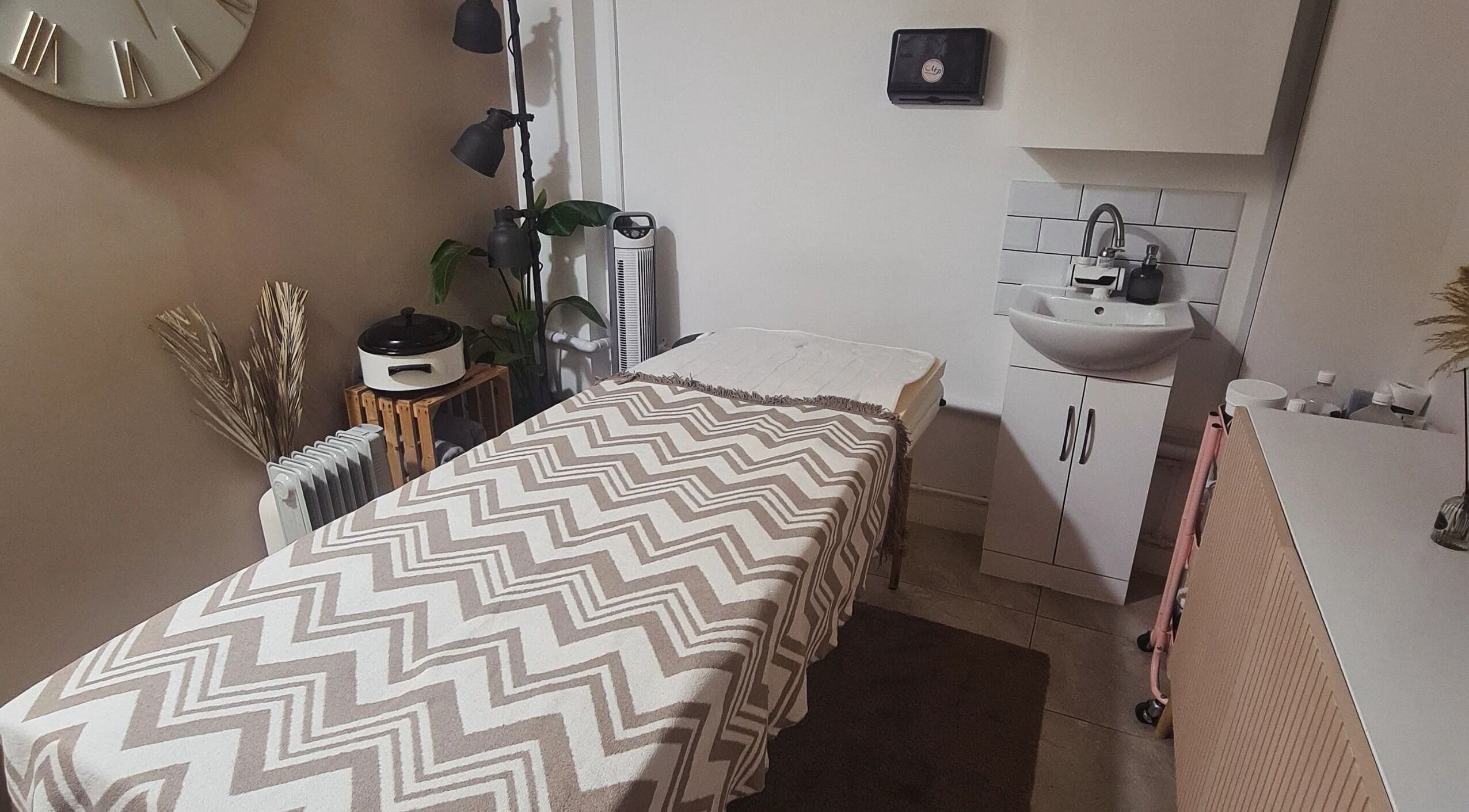 Tranquil therapy room at Happy Body - Massage & Physiotherapy, Peterborough, England, GB with warm decor.