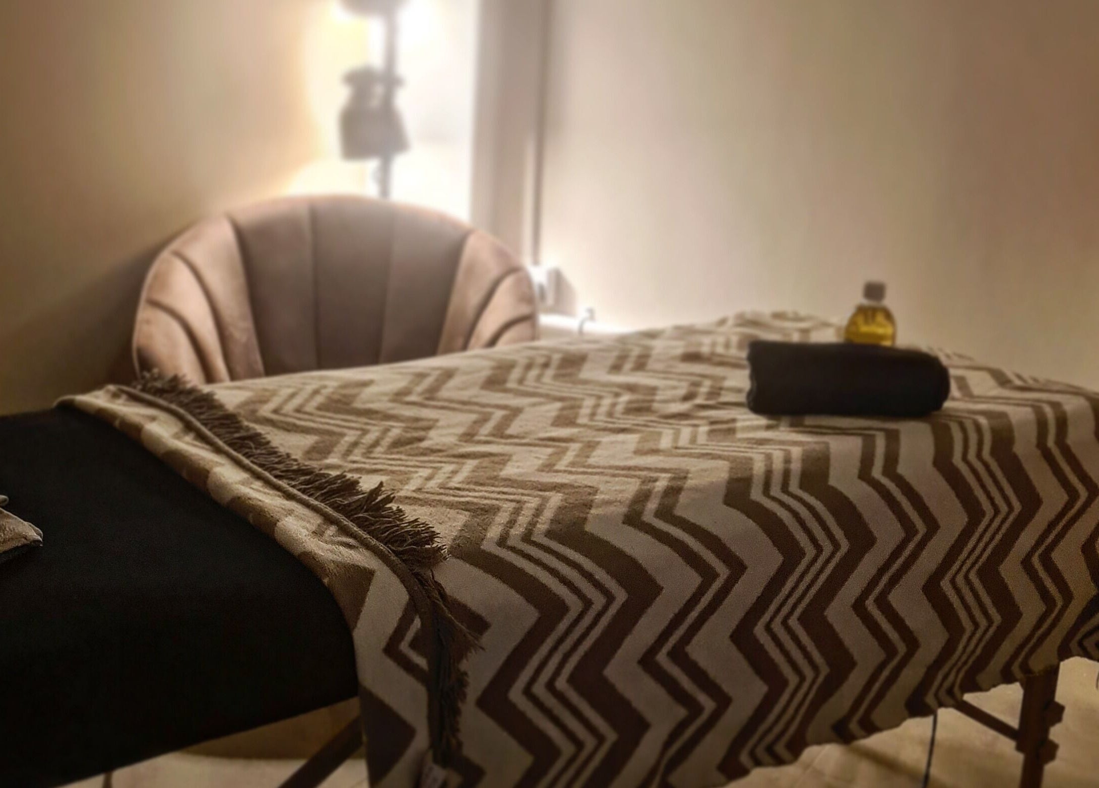 Relaxing massage room at Happy Body - Massage & Physiotherapy, Peterborough, England, GB, featuring a cozy table.