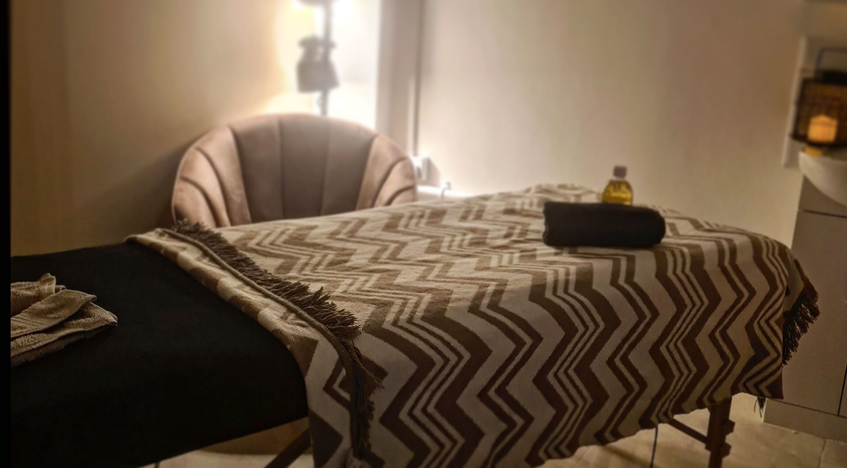 Relaxing massage room at Happy Body - Massage & Physiotherapy, Peterborough, England, GB, featuring a cozy table.