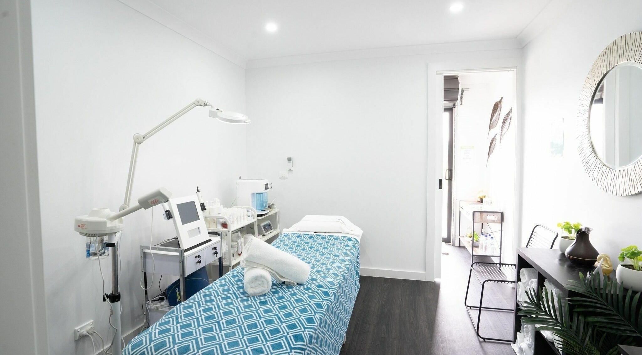 Calm treatment room at I Glow Skin Spa, Burnside, Victoria, AU, featuring a massage table and modern equipment.