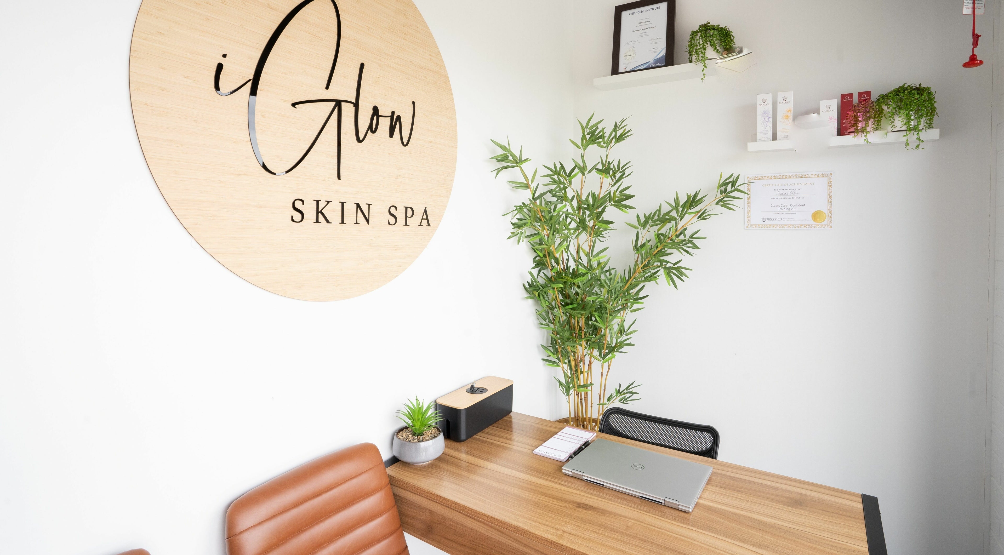 Reception area of I Glow Skin Spa in Burnside, Victoria, AU featuring a wooden desk and elegant decor.