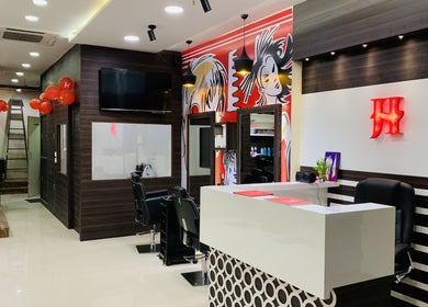 Jawed Habib Hair and Beauty - Sindhu Bhavan Road in Ahmedabad, Gujarat, IN. Modern salon interior with styling stations.