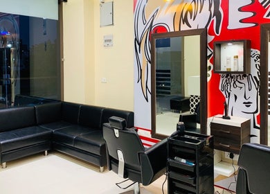 Stylish interior of Jawed Habib Hair and Beauty - Sindhu Bhavan Road in Ahmedabad, Gujarat, IN features black seating.