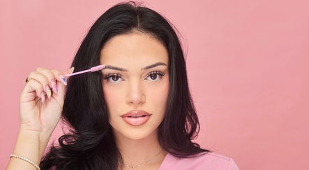 Woman using eyebrow brush at Victoria | Lashed Out by Vic in Vaughan, Ontario, CA. Enhance your beauty today.