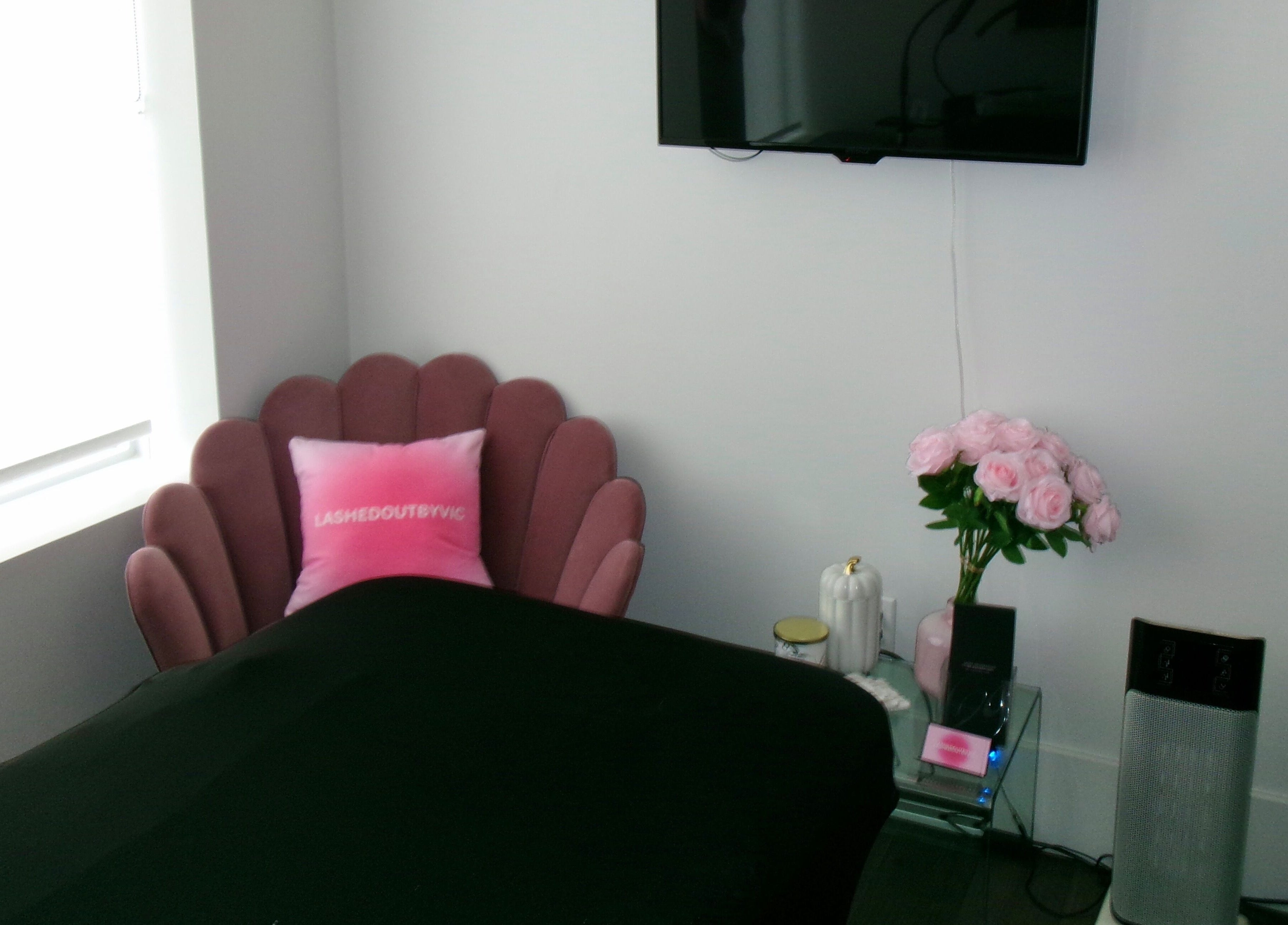 Elegant, cozy corner at Victoria | Lashed Out by Vic in Vaughan, Ontario, CA featuring a plush pink chair.