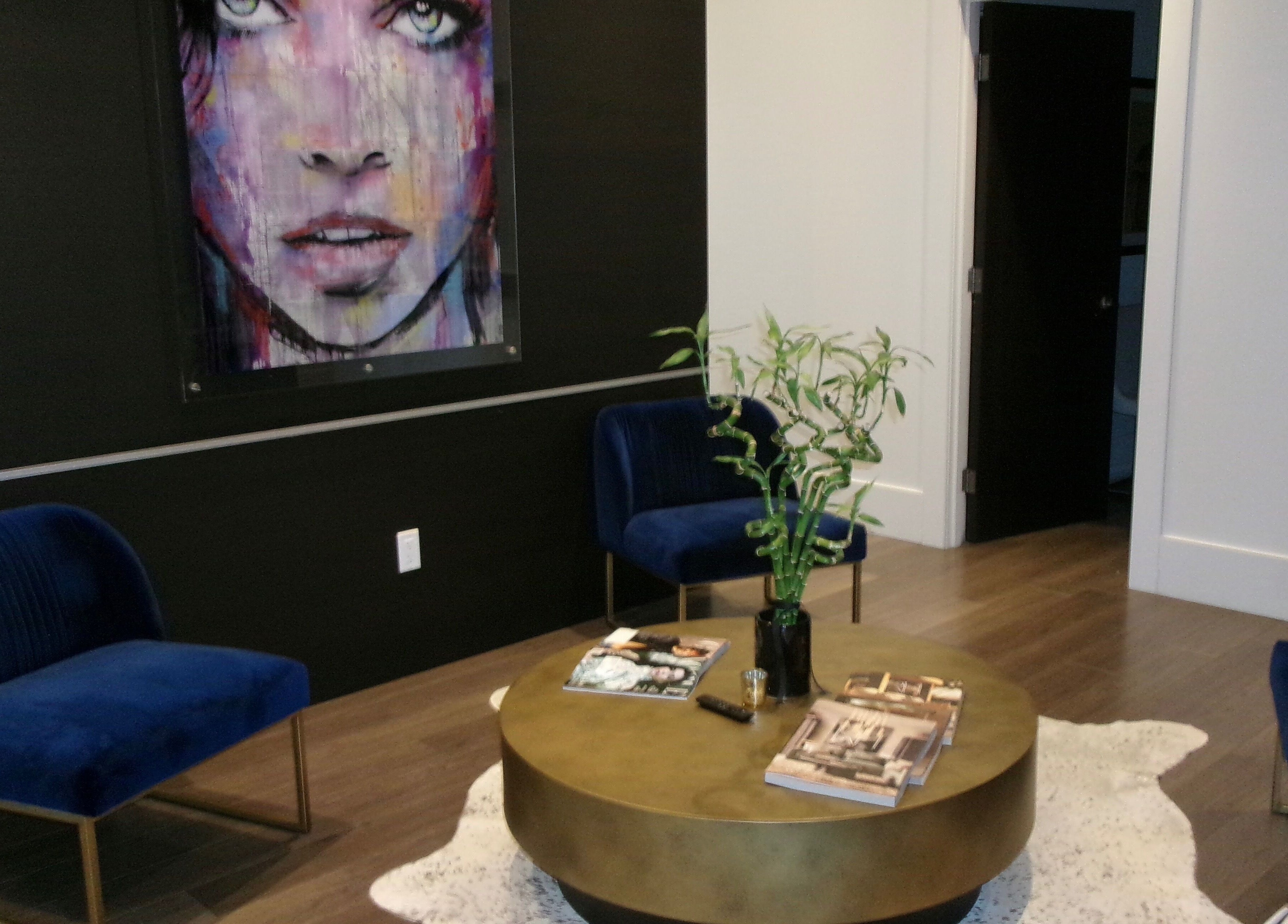 Stylish lounge at Victoria | Lashed Out by Vic, Vaughan, Ontario, CA featuring modern art and plush seating.