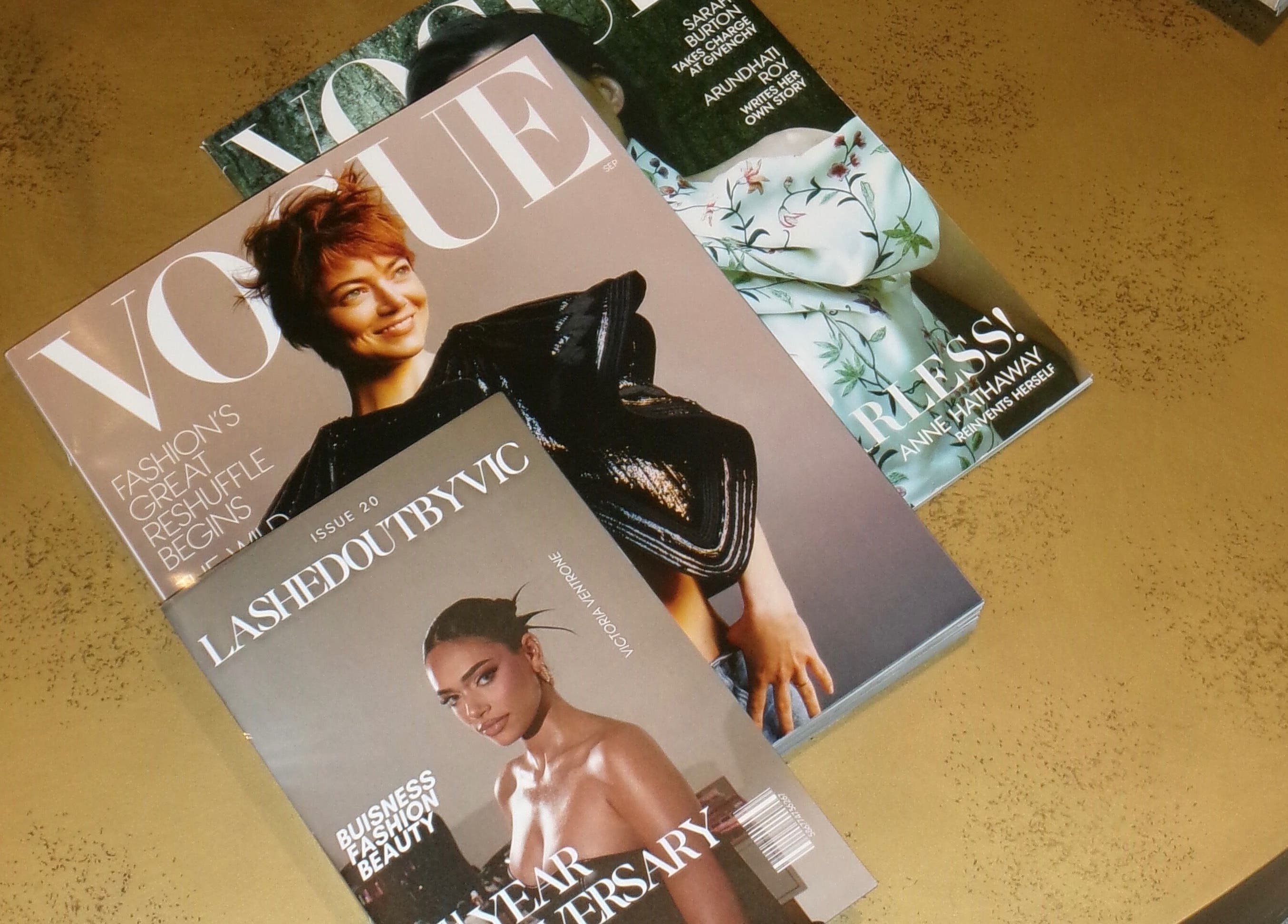 Stack of fashion magazines with Lashed Out by Vic on top at Victoria in Vaughan, Ontario, CA.