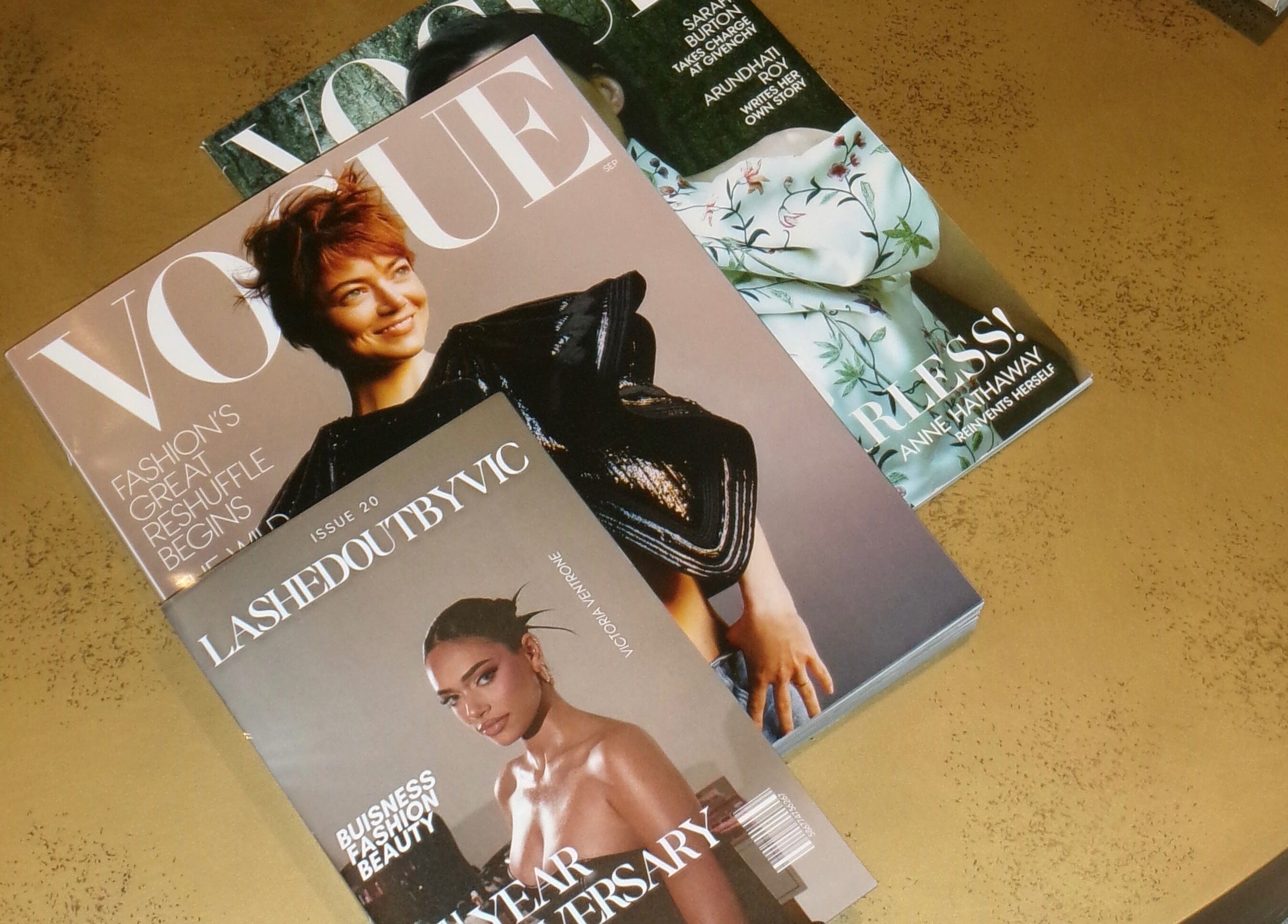 Stack of fashion magazines with Lashed Out by Vic on top at Victoria in Vaughan, Ontario, CA.