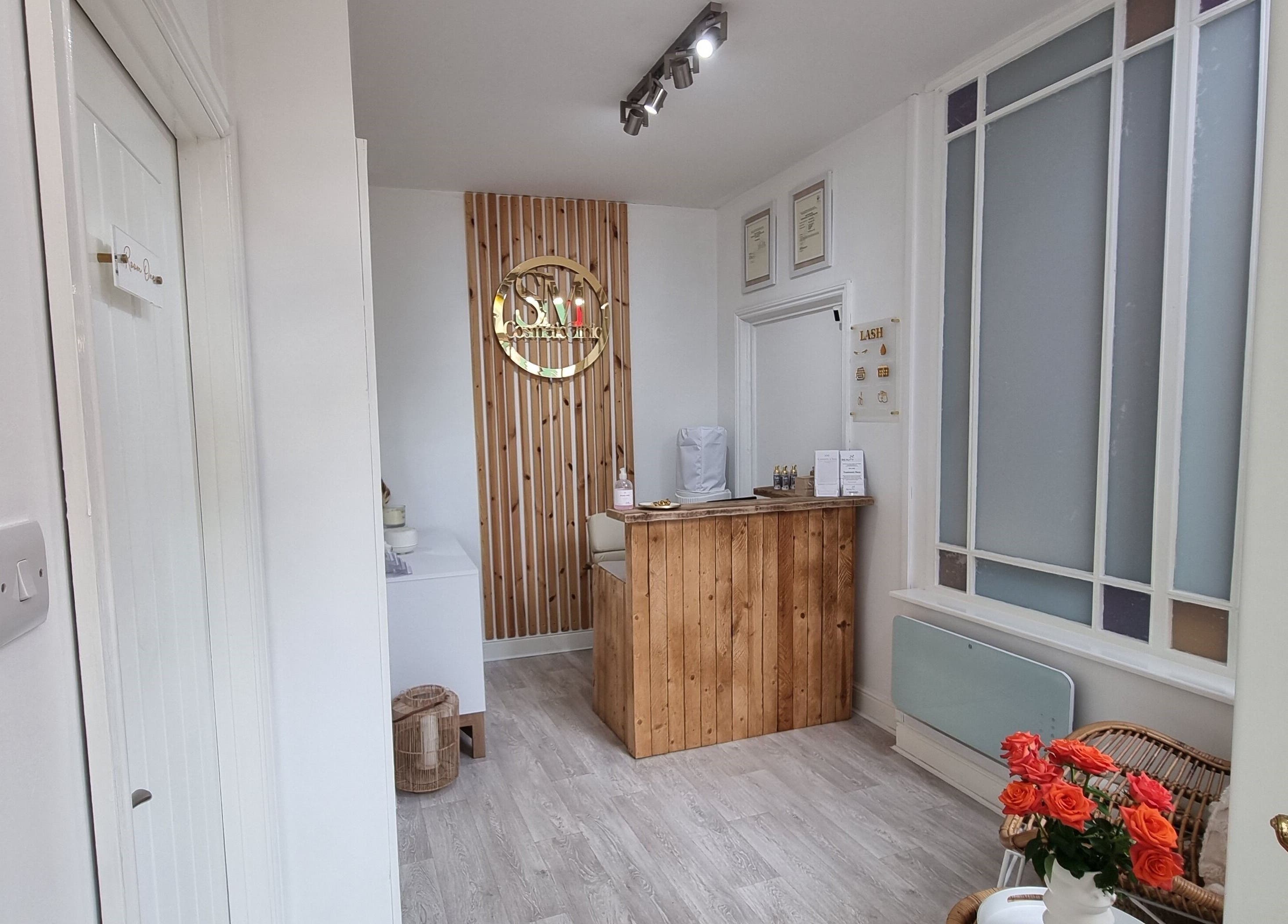 Welcoming reception area at Tide and Drift - Skin Therapy in Sheringham, England, GB with wooden decor.