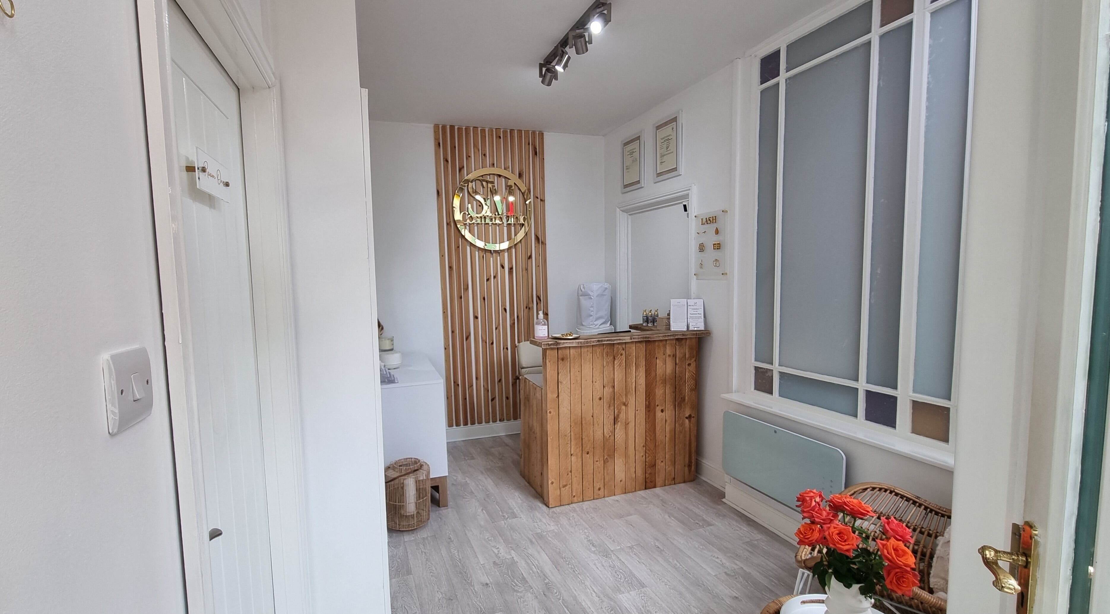 Welcoming reception area at Tide and Drift - Skin Therapy in Sheringham, England, GB with wooden decor.