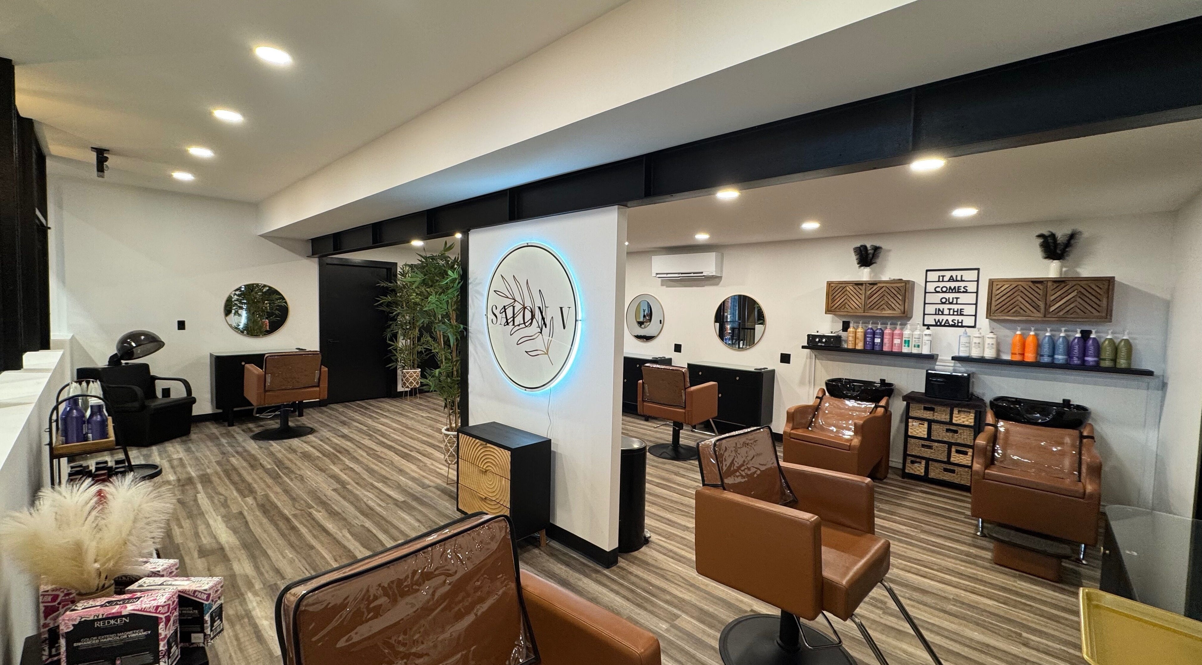 Inside view of Salon V in Fort Edward, New York, US, featuring chic styling chairs and decor.