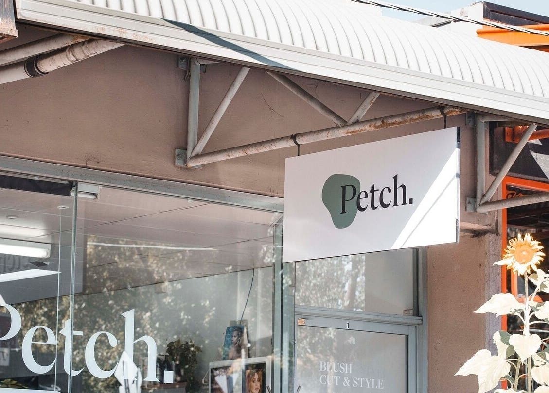 Front view of Petch Studio signage surrounded by sunflowers, located in Diamond Creek, Victoria, AU.