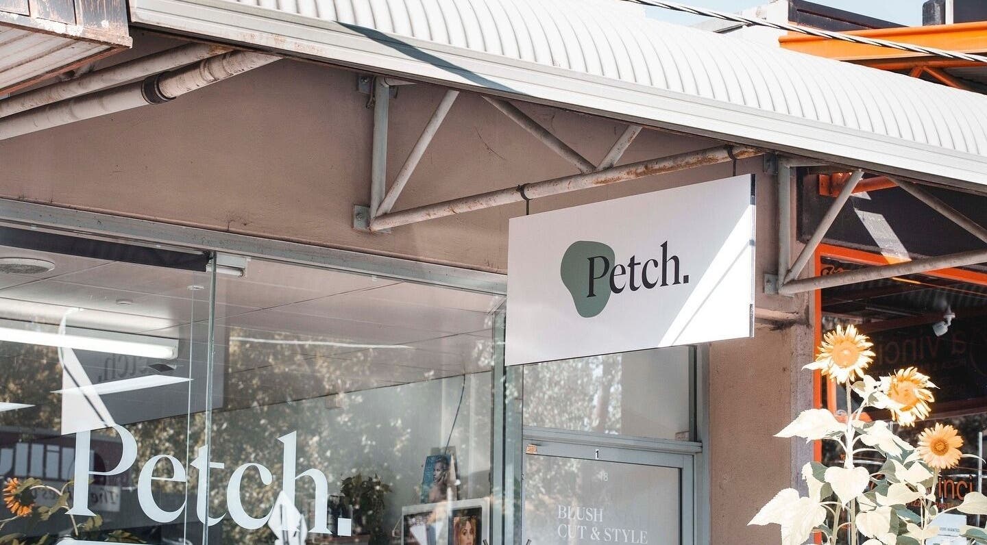 Front view of Petch Studio signage surrounded by sunflowers, located in Diamond Creek, Victoria, AU.