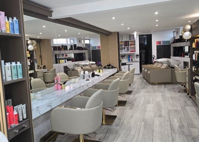 Chic interior of The Retreat@23/ Victoria Perkins Hairdressing in Knutsford, England, featuring modern styling stations.