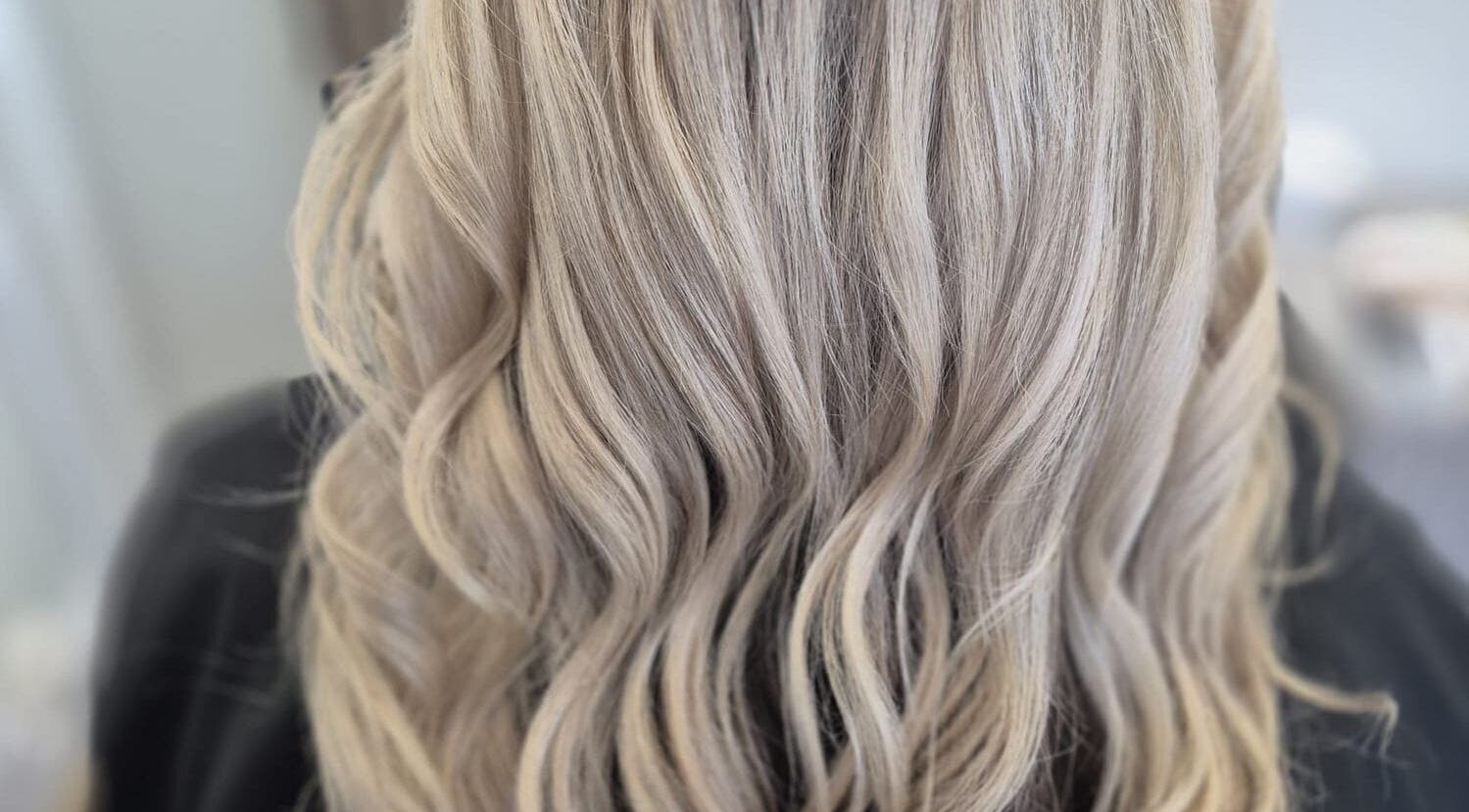 Blonde wavy hair styled at By Keeley, Leicester, England, GB for a glamorous look.