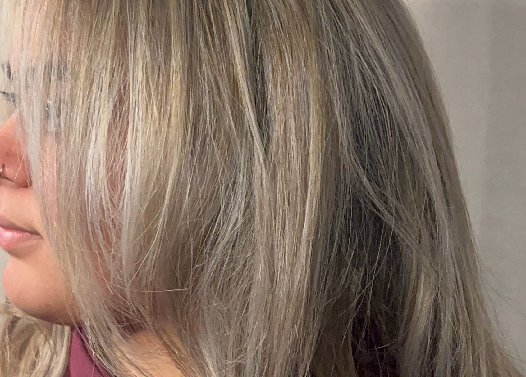 Close-up of styled silver hair at By Keeley, Leicester, England, GB showcasing sleek, textured layers.