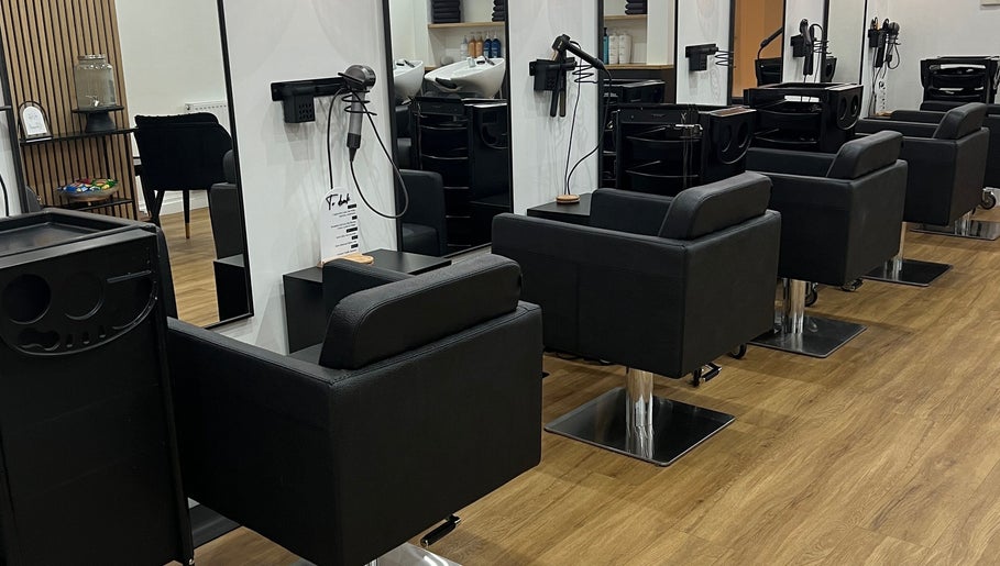 Modern salon chairs at The Hair Edit in Manchester, England, GB showcasing a sleek interior design.