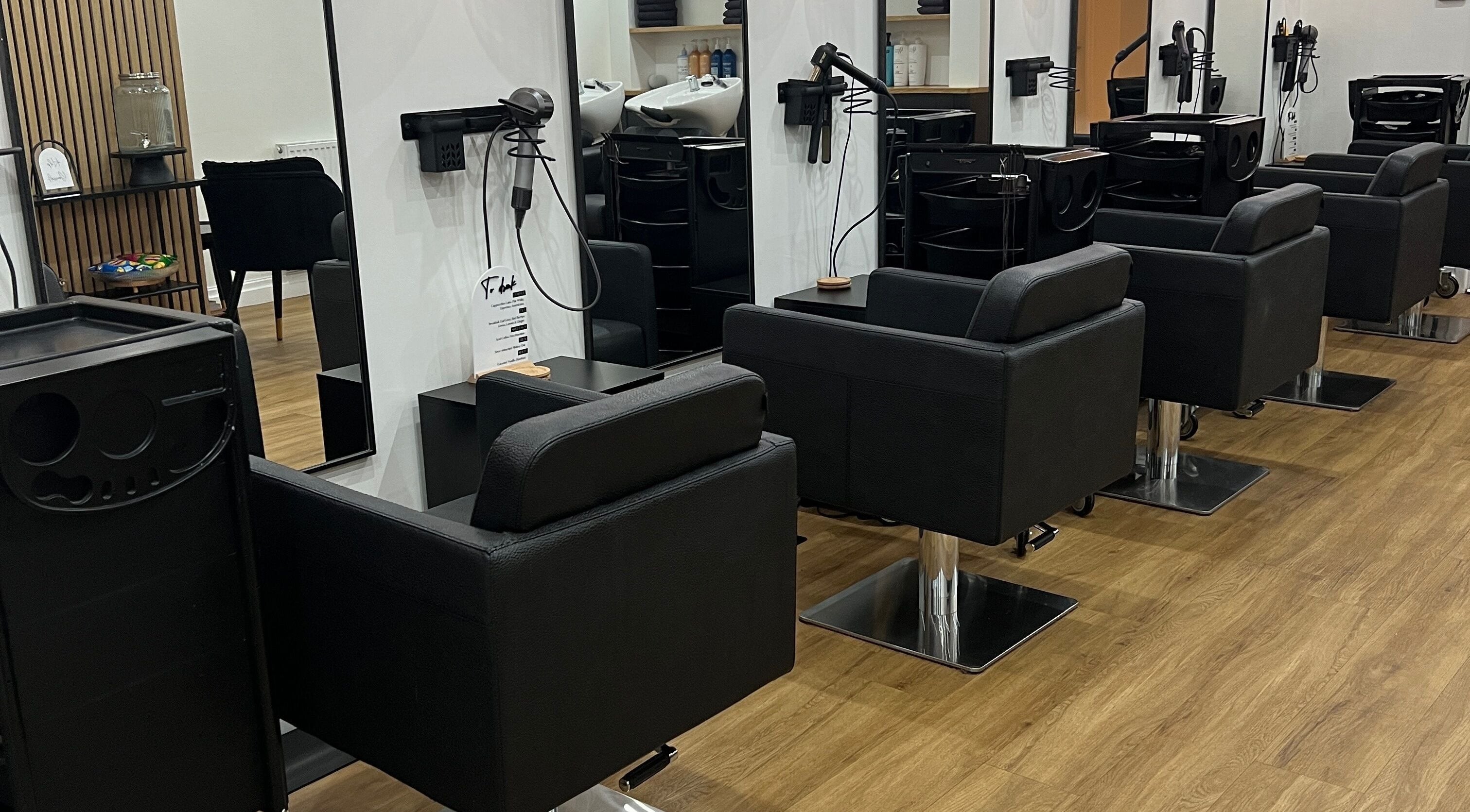 Modern salon chairs at The Hair Edit in Manchester, England, GB showcasing a sleek interior design.