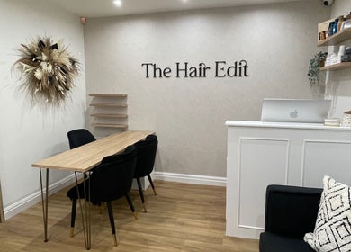 Cozy interior of The Hair Edit in Manchester, England, GB, featuring modern decor and seating area.