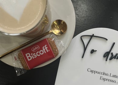 Cappuccino with Biscoff biscuit at The Hair Edit, Manchester, England, GB.