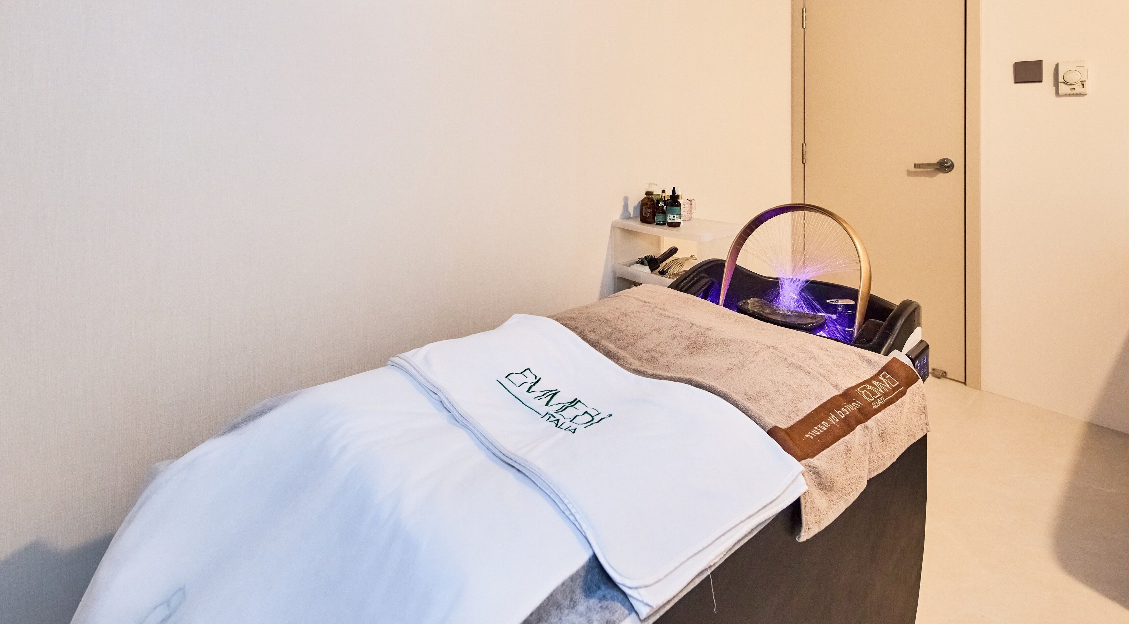 Relaxing spa bed at Emmebi Italia Head Spa HK Hair Spa Salon, Kowloon, Kowloon, HK, featuring soothing ambiance.