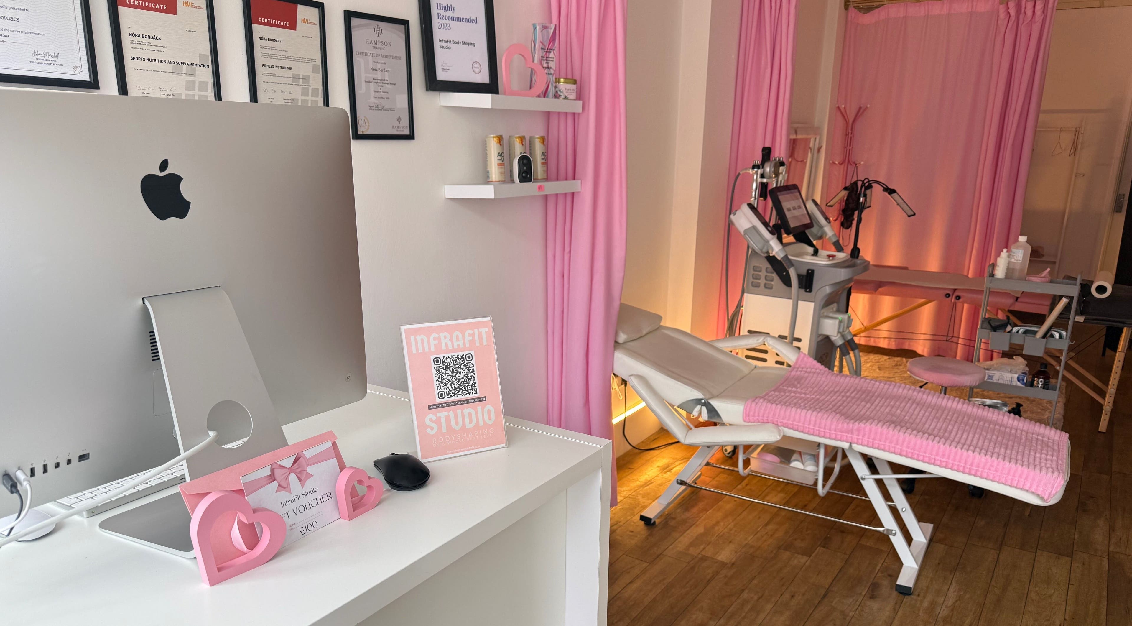 Modern treatment room at InfraFit Studio, Rugby, England, GB, featuring sleek equipment and calming pink decor.