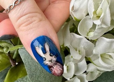 Close-up of chic bunny nail art at Radiance By Becca in Halifax, England, GB, with white flowers in the background.