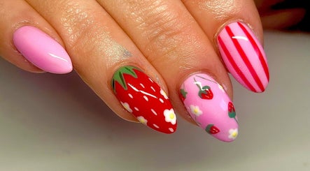 Strawberry-themed nail art at Radiance By Becca in Halifax, England, GB. Vibrant pink and red designs.