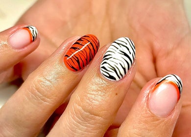 Close-up of zebra and tiger nail art at Radiance By Becca, Halifax, England, GB.