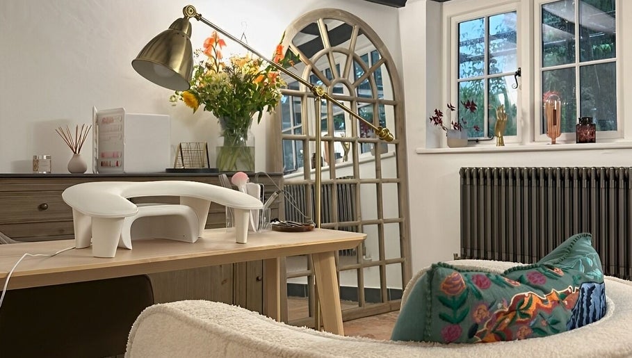 Elegant wellness setup at Sulking Room Studio, Horsham, England featuring a cozy chair and decorative elements.