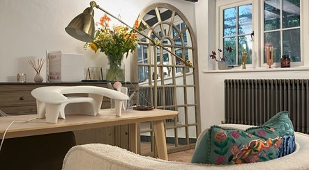 Elegant wellness setup at Sulking Room Studio, Horsham, England featuring a cozy chair and decorative elements.