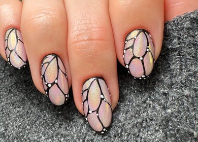 Intricate nail art at Sulking Room Studio, Horsham, England, GB, displaying detailed black and pastel designs.