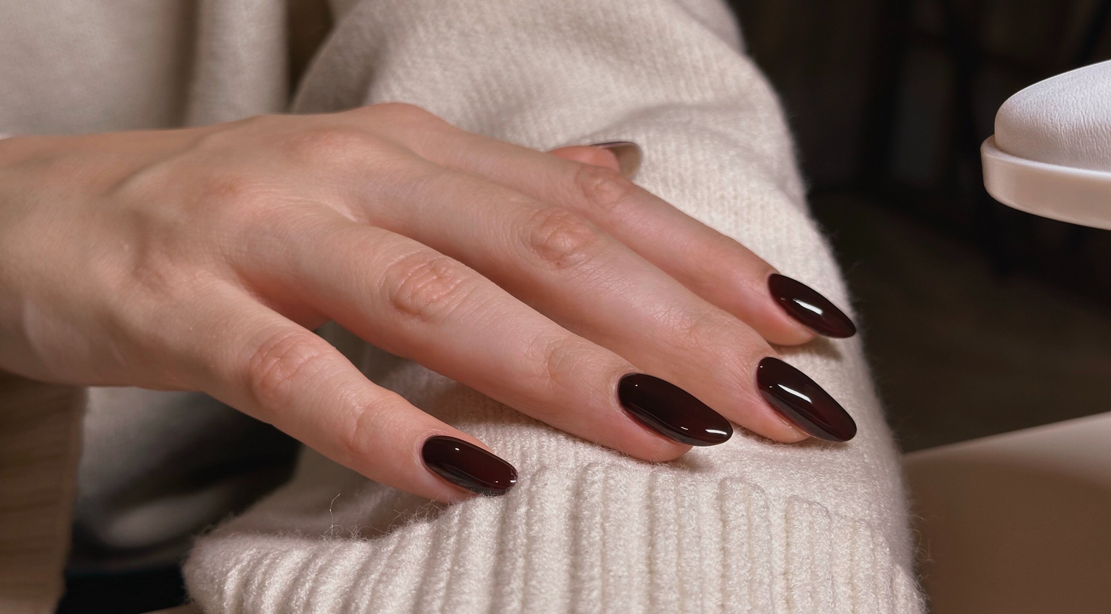 Claret red manicure at The Sulking Room, Horsham, England, GB. Perfectly shaped and glossy finish.